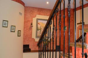 a staircase in a home with orange walls at Hotel Don Javier in Ronda