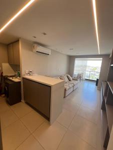 a room with a kitchen and a living room with a couch at Apartamento Stella Maris in Salvador