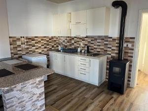 a kitchen with white cabinets and a stove at Apartments Visar in Ulcinj