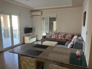 a living room with a couch and a table at Apartments Visar in Ulcinj