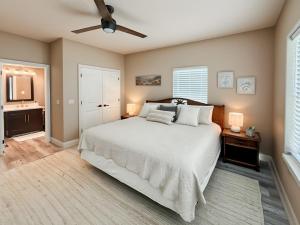 a bedroom with a bed and a ceiling fan at Beachfront Million Dollar Views 2 King Beds Big Tv in Galveston +45 photos
