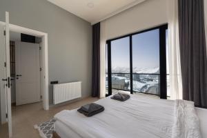 Postel nebo postele na pokoji v ubytování New Gudauri View Hotel
