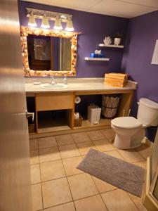 a bathroom with a sink and a mirror and a toilet at Ocean's Edge in Port Alice +43 photos