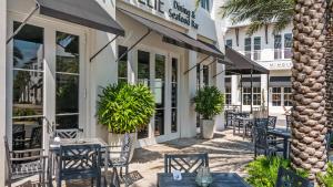 a restaurant with tables and chairs in front of a building at Lazy Days in Seacrest