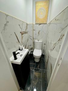 a bathroom with a white toilet and a sink at York's APPART in Saint-Herblain