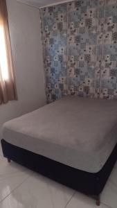 Postel nebo postele na pokoji v ubytování Santos house casa com dois quartos