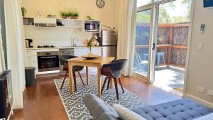 a kitchen and living room with a table and chairs at The Nature Resort Villas in Cowes
