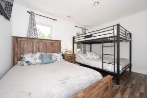 a bedroom with two bunk beds and a giraffe statue at Kernersville King Beds Hot Tub Arcade Firepit in Kernersville