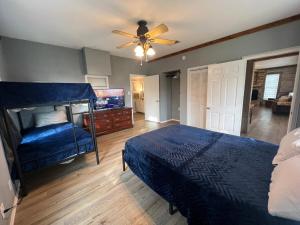 a bedroom with a bed and a ceiling fan at Farmhouse, Private Pool, Spa and Gym! Waco 30 min in Gatesville +55 photos