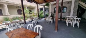 a restaurant with white chairs and tables on a patio at Pousada Boramar in Boracéia