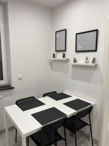 a white dining room with a table and chairs at Central Stadion Suite nähe Köln Bayer Stadion in Leverkusen +15 photos
