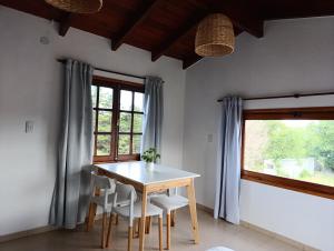 a dining room with a table and chairs and a window at Potrero Loft in Potrero de Garay