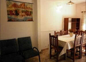 a dining room with a table and chairs and a painting at Duplex a 5 cuadras del mar con WiFi y TV Calle 36 y 6 in Santa Teresita