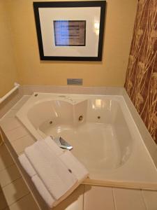 a white bath tub with towels in a bathroom at Country Inn & Suites by Radisson, Convention Center in Altoona