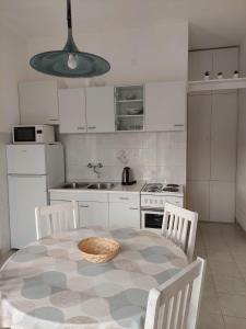 a kitchen with a table with a bowl on it at Apartments with parking space Postira, Brac - 700 in Postira +16 photos