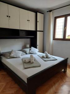 a bedroom with a large bed with towels on it at Apartments with parking space Postira, Brac - 700 in Postira