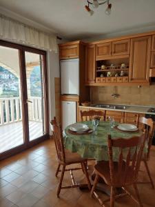 a kitchen with a table with chairs and a refrigerator at Apartments with parking space Postira, Brac - 700 in Postira