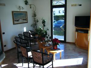 a dining room with a table and chairs and a television at Residence Vezzoli in Boario Terme