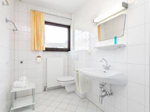 a white bathroom with a sink and a toilet at Brixen Alpin Living Top 13 in Brixen im Thale +45 photos