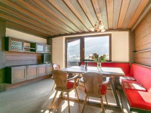 a dining room with a table and chairs and a window at Brixen Alpin Living Top 16 in Brixen im Thale +41 photos
