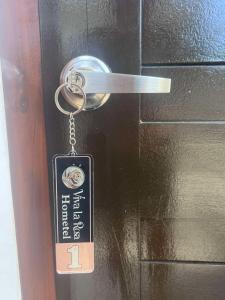 a key chain is attached to a door at Viva La Rosa Hometel in Anda