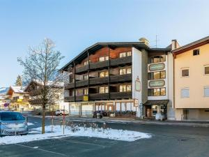 a building on the side of a street with a parking lot at Brixen Alpin Living Top Alle in Brixen im Thale