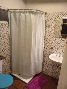 a bathroom with a shower and a sink at Casa wairaluna in Capilla del Monte