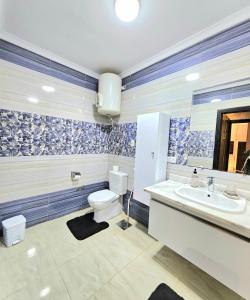 a bathroom with a toilet and a sink at Beautiful appartement. In Cairo Madinaty in Cairo +42 photos