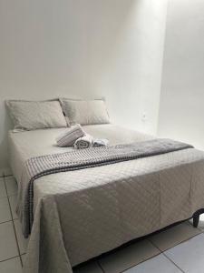 a bed with two towels on top of it at Casa jardim ao lado da BR-242 in Barreiras