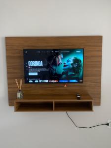 a flat screen tv sitting on top of a tv stand at Casa jardim ao lado da BR-242 in Barreiras