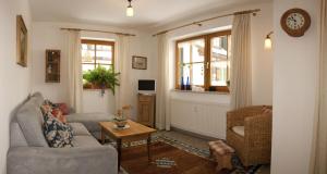 a living room with a couch and a table at Appartements Alpenresidenz in Weitnau