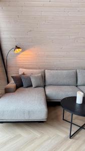 a living room with a couch and a table at Monteluce Aframe in Mărişel