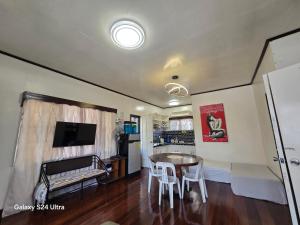 a kitchen and living room with a table and chairs at Hillside Vacationers homestay in Baguio