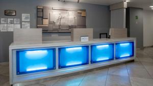 a row of blue fish tanks in a room at Holiday Inn Express Mexico Santa Fe by IHG in Mexico City