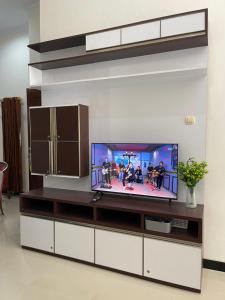 a living room with a tv in a wall at Rdk Homestay in Jarakan