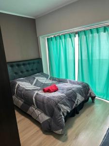 a bed sitting in a bedroom with a window at Naomi in Mar del Plata