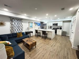 a living room with a blue couch and a kitchen at Beautiful Cozy Home in DC with Easy Parking in Washington