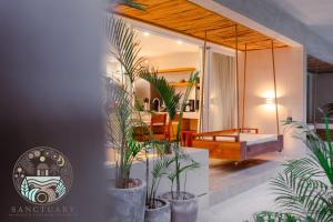 a room with potted plants and a room with a swing at New 1BR with Jacuzzi & Free Access to Akna Beach Club in Tulum +82 photos