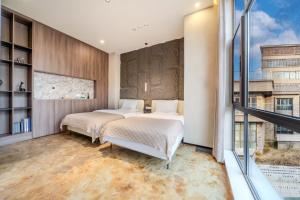 Xiyou Hotel Xi'an City Wall Branch禧又HOTEL客房内的一张或多张床位
