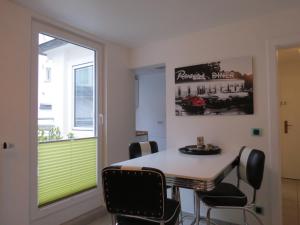 a dining room with a table and chairs and a window at Hotel Sechzehn in Leverkusen