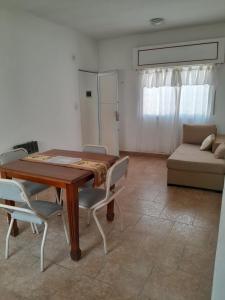 a dining room with a table and chairs and a couch at Milli in Gualeguaychú