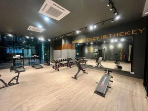 a gym with treadmills and machines in a room at Studio at dMillenia Residences in Kota Samarahan