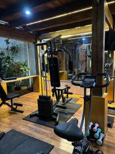 a gym with several treadmills and exercise bikes at Villa Lisha Orolas in Blimbing