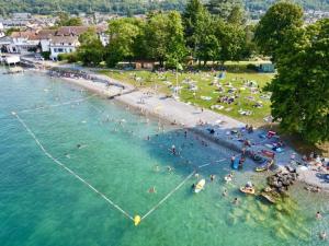 a group of people in the water at a beach at Confortable appartement 1 chambre près plage et lac avec garage - FR-1-498-111 in Publier +2 photos