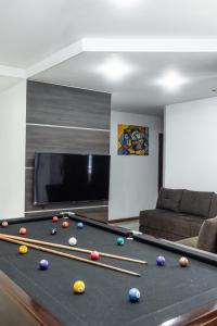 a living room with a pool table with balls on it at Casa10inn hst in Serra