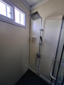 a shower stall in a bathroom with a window at Yin Garden Lodge Fortuna in Fortuna +7 photos