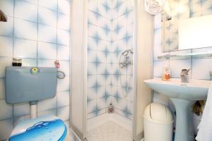a small bathroom with a toilet and a sink at Apartment Ruža 2021 in Premantura +16 photos