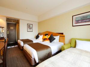 Uma cama ou camas num quarto em Hotel Resol Gifu