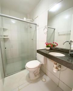 a bathroom with a toilet and a shower and a sink at iapôi Beira-Mar Maracaípe in Porto De Galinhas