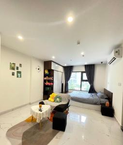 a living room with a bed and a couch and a table at BS8 Vinhome Grand Park - Vin Wonder in Long Bình